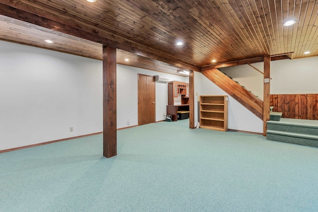 basement with carpet flooring, an AC wall unit, wooden ceiling, and wood walls