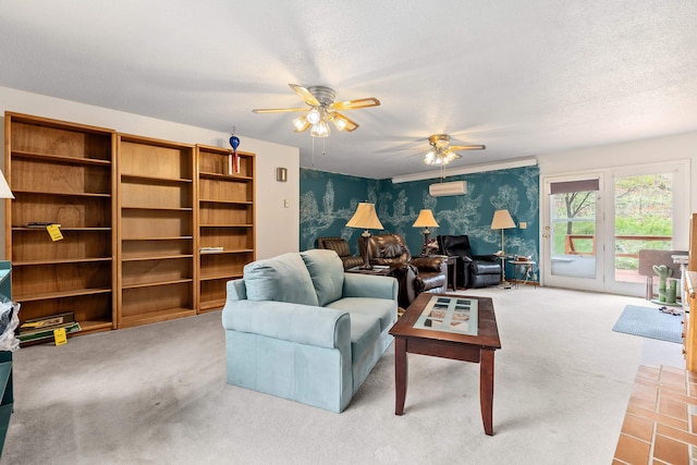 carpeted living room with a wall mounted AC, a textured ceiling, and ceiling fan