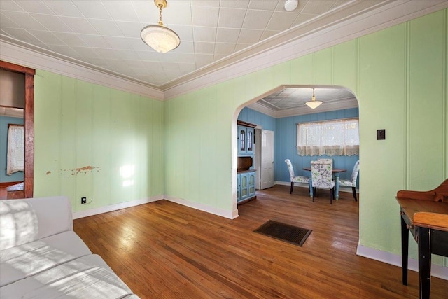 sitting room with dark hardwood / wood-style floors and crown molding