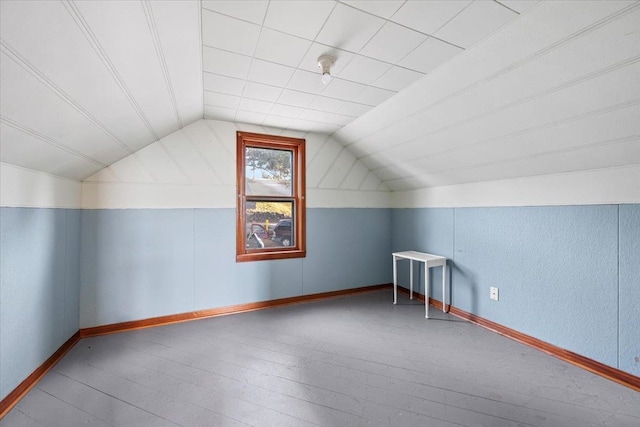 bonus room with wood-type flooring and vaulted ceiling