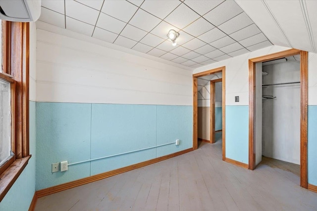 interior space with light hardwood / wood-style floors and lofted ceiling