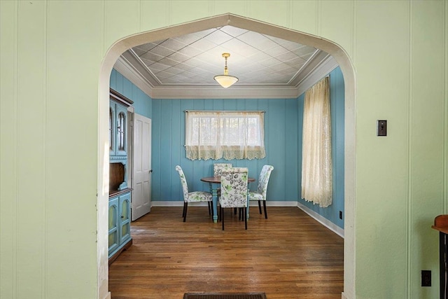 dining room with dark hardwood / wood-style floors and crown molding