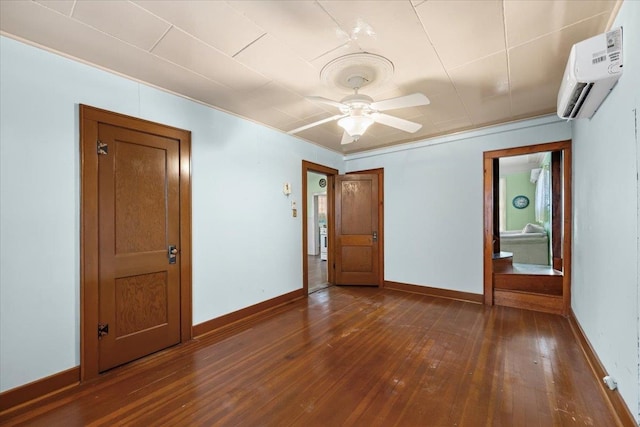 unfurnished room featuring ceiling fan, dark wood-type flooring, and a wall mounted air conditioner