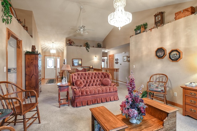 carpeted living room with high vaulted ceiling and ceiling fan with notable chandelier