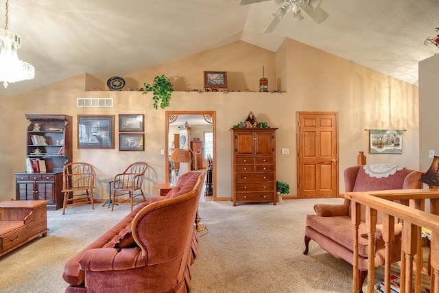 carpeted living room featuring ceiling fan and vaulted ceiling