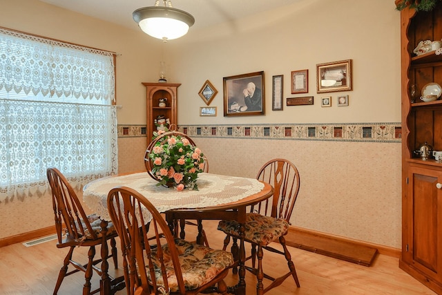 dining space featuring light wood-type flooring