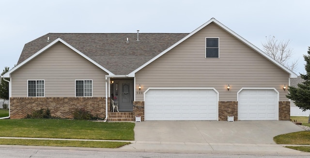 view of front of house featuring a garage and a front lawn