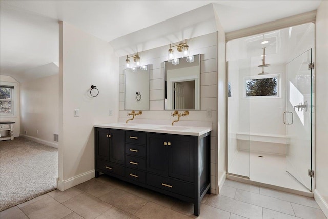 bathroom featuring tile patterned flooring, vanity, and a shower with door