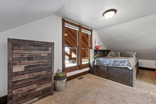 bedroom featuring carpet flooring and vaulted ceiling