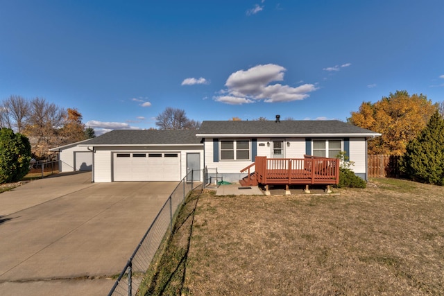 view of front of property with a deck, a front lawn, and a garage