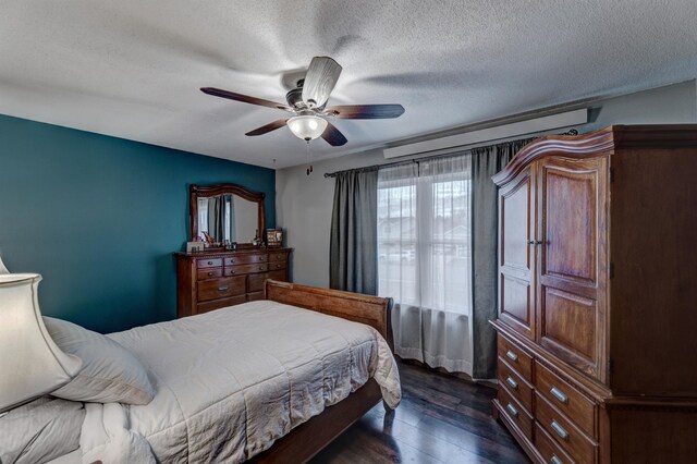 bedroom featuring a textured ceiling, ceiling fan, and dark hardwood / wood-style floors