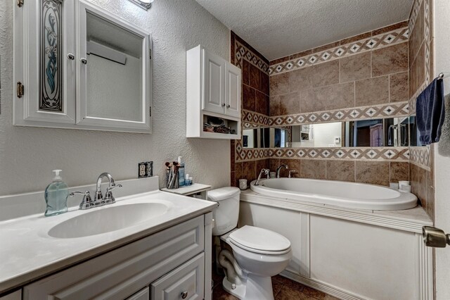 bathroom featuring vanity, a textured ceiling, and toilet