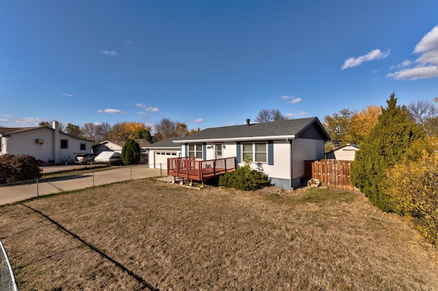 view of front of property with a wooden deck and a front lawn