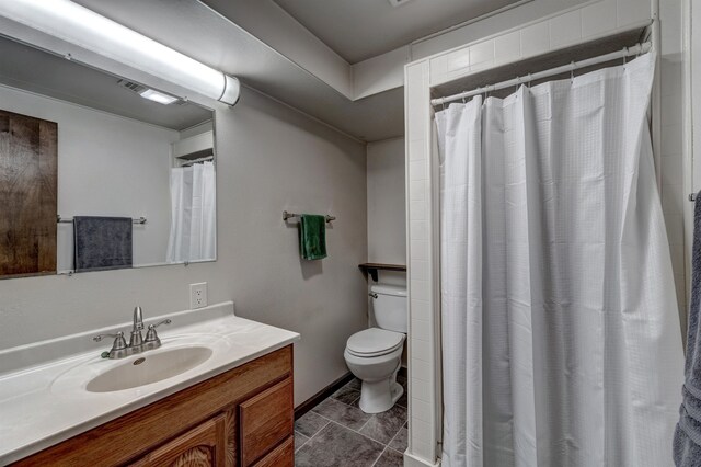 bathroom with tile patterned floors, vanity, curtained shower, and toilet