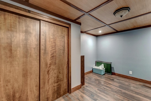 basement featuring crown molding and hardwood / wood-style flooring