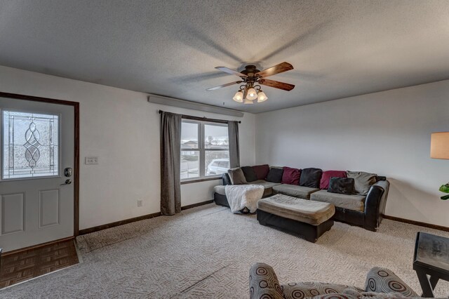 carpeted living room with a textured ceiling and ceiling fan