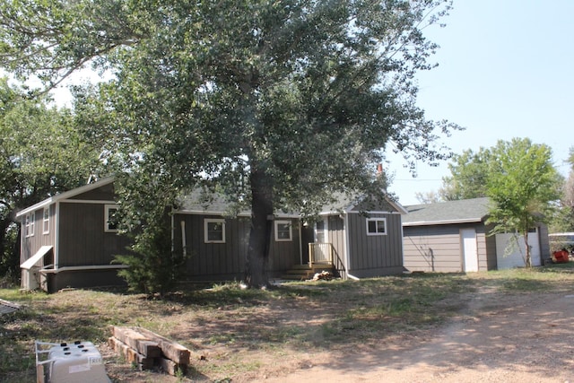 view of front of house featuring a garage and an outdoor structure