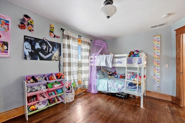 bedroom with dark wood-type flooring