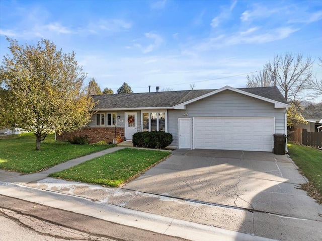 ranch-style home with a garage and a front lawn