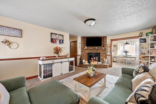 carpeted living room featuring a fireplace and a textured ceiling