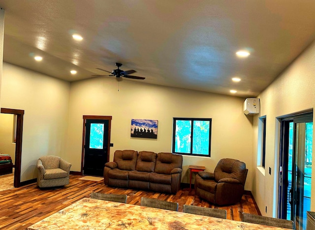 living room featuring wood-type flooring, an AC wall unit, and ceiling fan