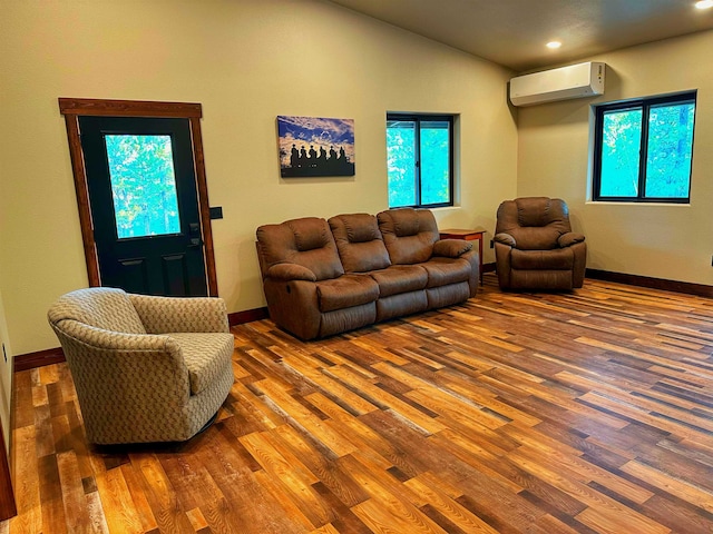 living room with wood-type flooring and a wall mounted air conditioner