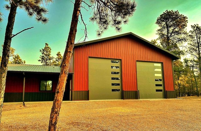 view of garage at dusk