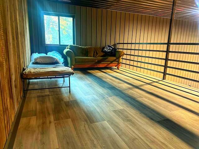 living area featuring wood-type flooring and wooden walls