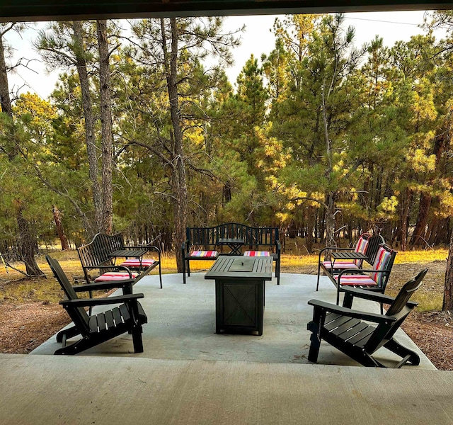 view of home's community with a patio and a fire pit