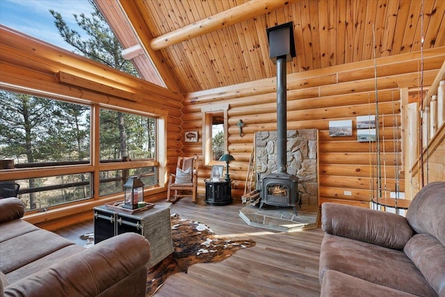 living room with beamed ceiling, wood-type flooring, high vaulted ceiling, and a wood stove