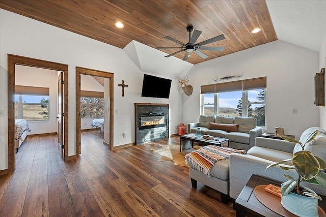 living room with ceiling fan, dark wood-type flooring, a healthy amount of sunlight, and vaulted ceiling