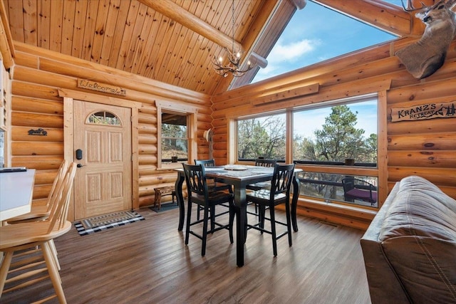 dining area featuring dark hardwood / wood-style floors, beam ceiling, high vaulted ceiling, and a chandelier