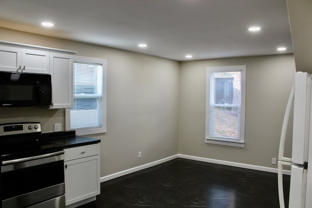 kitchen featuring white cabinetry, electric range, and white refrigerator