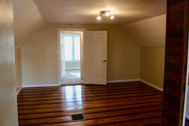 bonus room featuring dark hardwood / wood-style floors and lofted ceiling