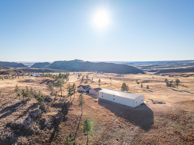 drone / aerial view featuring a mountain view and a rural view