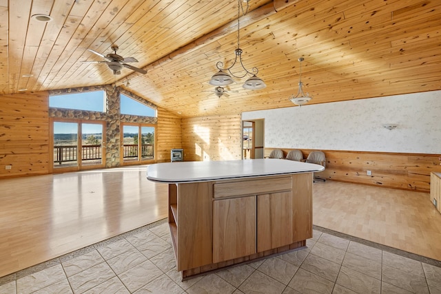 kitchen featuring pendant lighting, lofted ceiling, wooden ceiling, light wood-type flooring, and a kitchen island