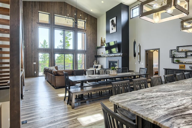 dining room featuring hardwood / wood-style floors, high vaulted ceiling, and a chandelier