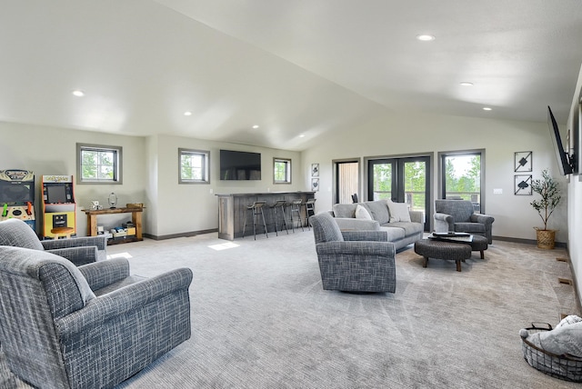 carpeted living room with lofted ceiling and indoor bar