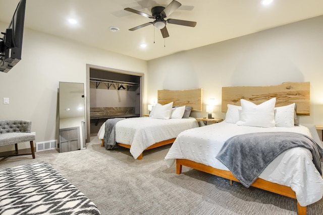 carpeted bedroom with ceiling fan and a closet