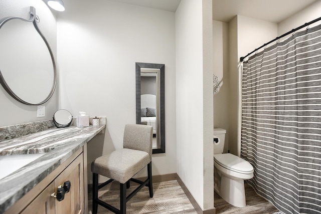 bathroom featuring hardwood / wood-style floors, vanity, and toilet