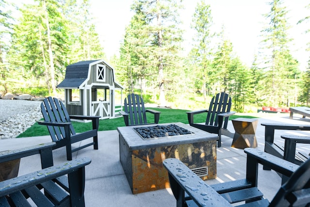 view of patio featuring a fire pit and an outdoor structure