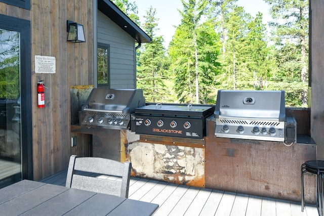 wooden deck featuring a grill and exterior kitchen