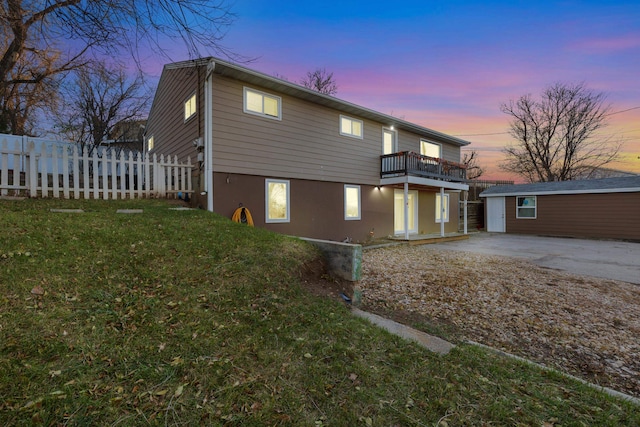 exterior space with a yard, a balcony, and an outdoor structure