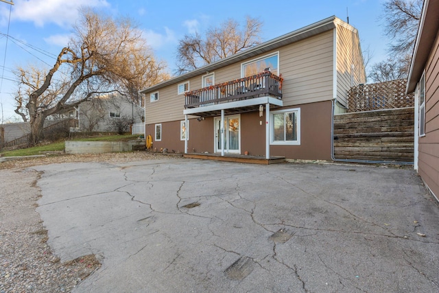 rear view of property featuring a balcony