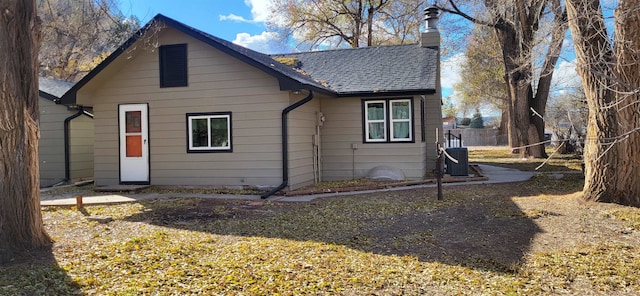 rear view of property featuring central AC unit