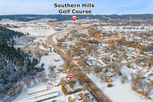 snowy aerial view with a mountain view