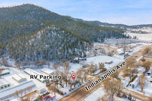 snowy aerial view with a mountain view