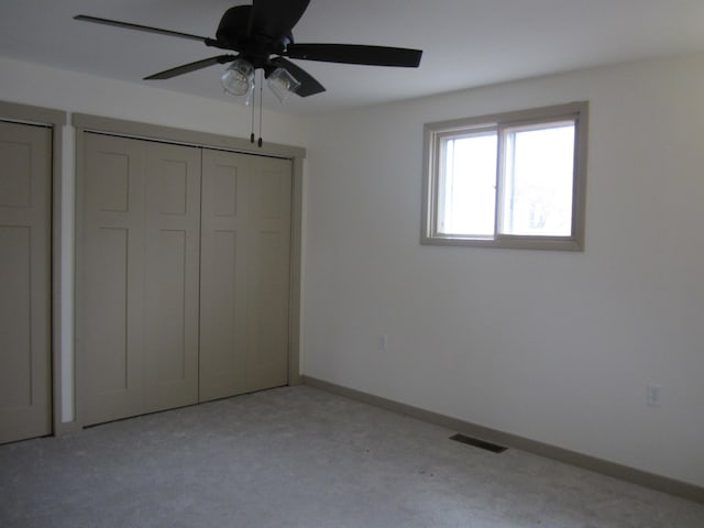 unfurnished bedroom featuring ceiling fan and light carpet