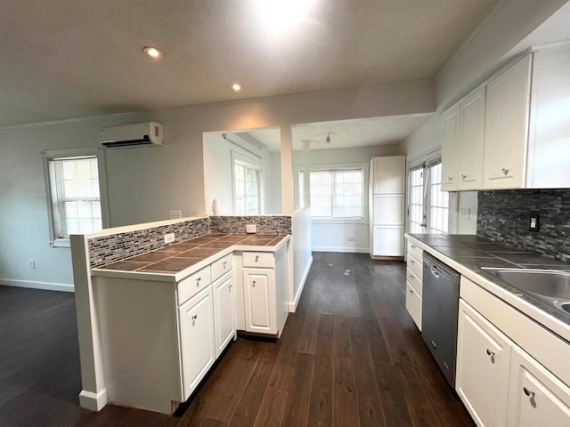 kitchen with backsplash, white cabinets, a wall mounted AC, dishwasher, and dark hardwood / wood-style floors