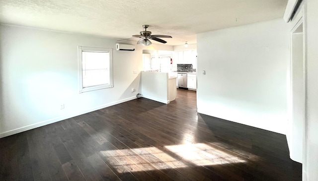 unfurnished living room featuring a textured ceiling, ceiling fan, dark hardwood / wood-style floors, and an AC wall unit